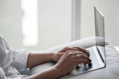 Close up man lying on sofa with laptop Stock Photos