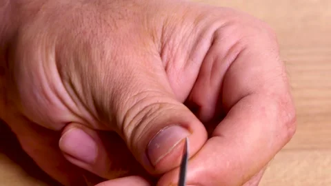 Close-up a man  manicuring his nails with a manicure tool Stock Footage 250483836