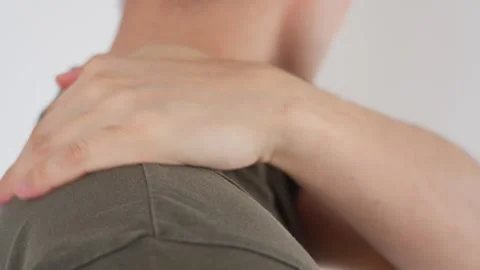 Close-up of a man massaging his shoulder showing signs of fatigue and pain Stock Footage 285356041