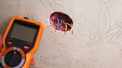 Close-up of man measuring and cheking power supply voltage Stock Footage 93441326