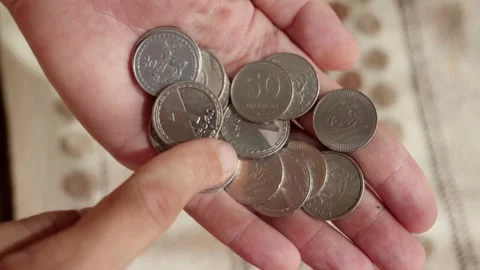 Close-up of man methodically counting georgian lari coins. Stock Footage 283755872