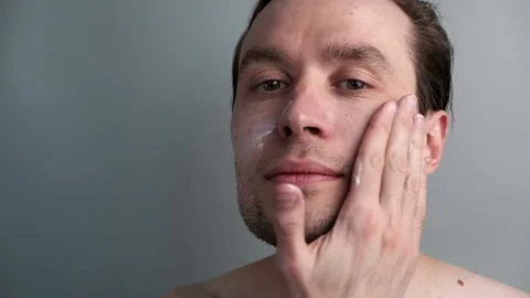 Close up of a man with moisturizer for his face. Stock Footage 172430790