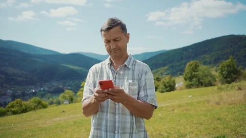 Close up man in the mountains use phone technology a concept of connection with Stock Footage 116997715
