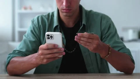 Close up man online banking using smartphone shopping online with credit card at Stock Footage 204832663