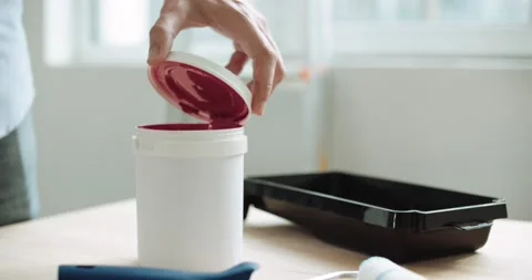 Close-up of a man opening a can of pink paint Stock Footage 155796531