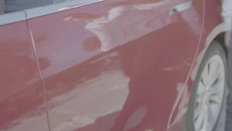 Close up of man opening Tesla door Video stock 74697737