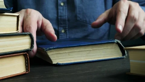 Close-up man opens and reads an old book. Stock Footage 130903002