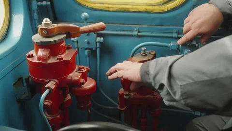 Close-up of man operating driving old train locomotive, adjusting gas Stock Footage 272791684