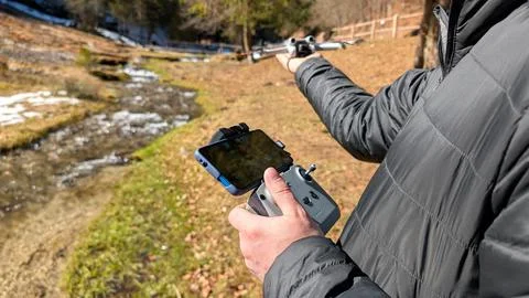 Close Up Of Man Operating Drone Controller With Stream Background Stock Photos