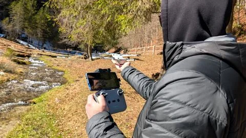 Close Up Of Man Operating Drone Controller With Stream Background Stock Photos