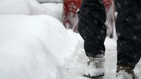 Close-up of man operating a snow blower during a winter storm. Stock Footage 124333516