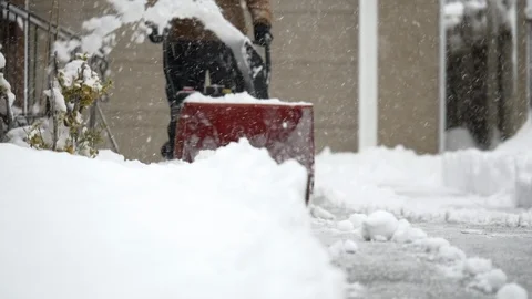 Close-up of man operating a snow blower during a winter storm. Stock Footage 124334287