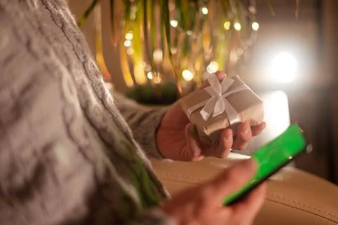 Close-up man orders a gift in an online store using a smartphone. online shop Stock Photos
