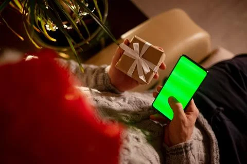 Close-up A man orders a gift in an online store using a smartphone for his Stock Photos