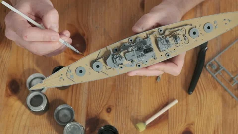 Close-up of man painting elements   of layout warship with brush. Stock Footage 168894514
