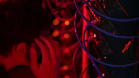 Close up of a man panicking in a server room with flashing red lights 動画素材 287370926