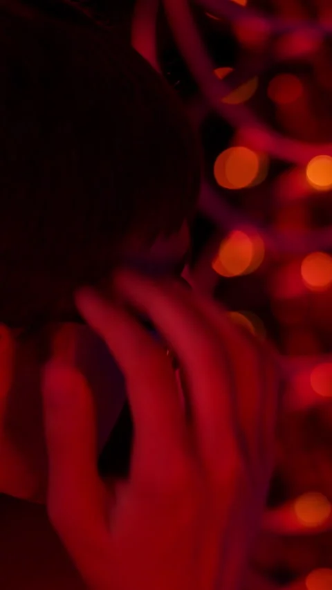 Close up of a man panicking in a server room with flashing red lights. Vertical Stock Footage 287378983