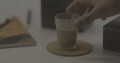 Close up of a man picking up Chai Tea - Shot on RED 5K 動画素材 113604958