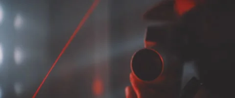 Close up of man playing around laser light with vintage camera Stock Footage 203561165