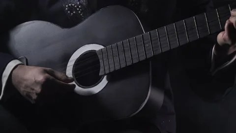 Close up of a man playing black and white guitar, Santa Muerte, 4k Stock Footage 138426017