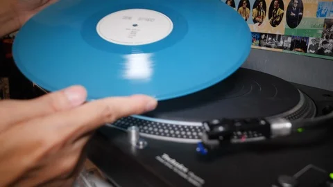 Close up of man playing blue vinyl record in shop, Kuala Lumpur, Malaysia Stock Footage 146546149