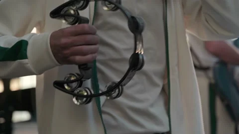 Close-up of a man playing during an acoustic music concert on a tambourine in a Video stock 195121304