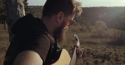 Close up man is playing at the guitar Stock Footage 134574016