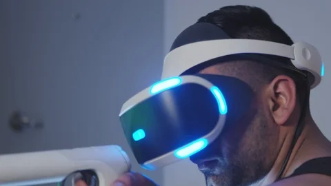 Close Up of Man Playing Gun Game in Virtual Reality with Rifle and Goggles Stock Footage 108882123