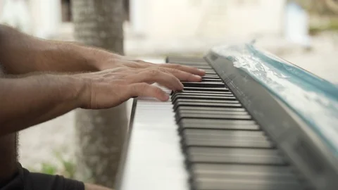 Close up of man playing on keyboard in nature, Mexico Stock Footage 122379826