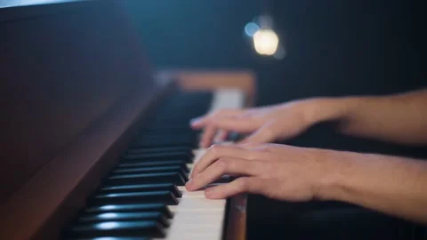 A close-up of a man playing an old upright piano Stock-Footage 237761856
