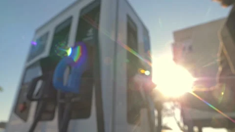 Close Up of Man Plugging Charging Cable Into Electric Vehicle Outside Stockbeeldmateriaal 337284192