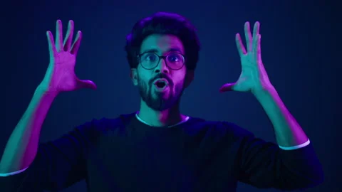 Close up man portrait Muslim coder in neon studio ultraviolet background Arabian Stock Footage 248428983