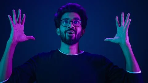 Close up man portrait Muslim coder in neon studio ultraviolet background Arabian Foto stock