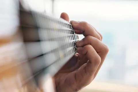 Close-up Of Man Practising Chords With Classical Guitar Stock Photos