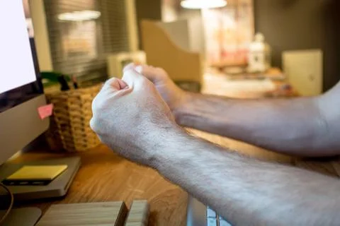 Close-up of a man praying with the typical hands gesture in front of the scre Stock Photos