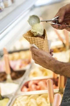 Close-up of a man preparing a multi flavored ice cream cone Stock Photos