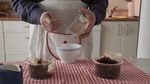 Close-up of a man preparing oatmeal for breakfast Stock Footage 307742628