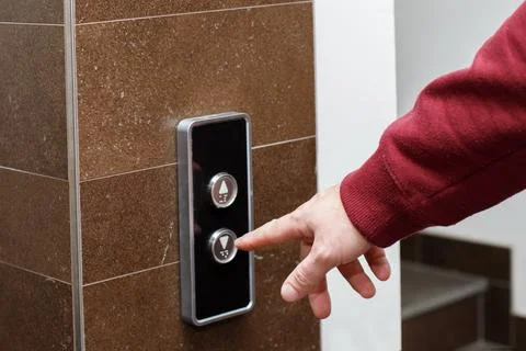 Close-up man presses the button to call the elevator Foto stock