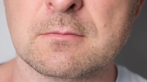 Close-up of a man pressing lips together while shaking head no. Facial Stock Footage 337866000