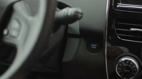 Close up of a man pressing the start button in an electric car Video stock 135596235