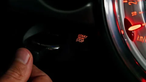 Close up of a man pressing the Start Stop engine on a car and taking the key out Stock Footage 311570441