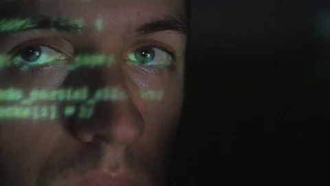 Close up Man programmer hacker working on a computer while green code characters Stock Footage 85365954