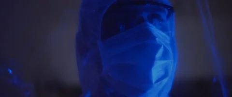 Close up of a man in protective suit with mask and glasses,looking around Stock Footage 126357541