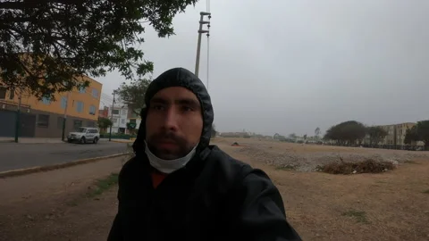 Close-up of a man pulling up his mask while running Stock Footage 140564866