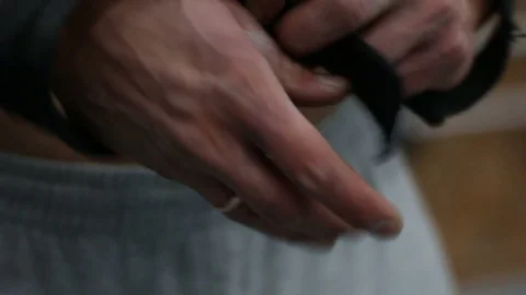 Close up man pulls the belt on the hand before exercise. Stock Footage 76969281