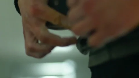 Close up man pulls the belt before lifting exercise in the gym Video stock 77568927