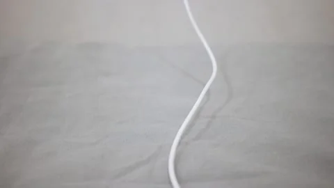 Close-up. The man pulls out a mobile phone charger from Stockbeeldmateriaal 150331912