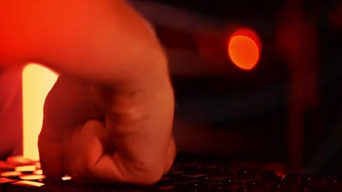 Close up of a man punching the keypad on a computer in a server room with Stock Footage 287370869