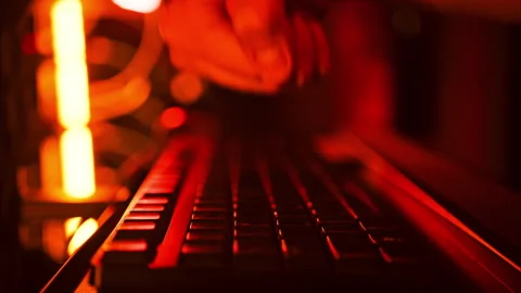 Close up of a man punching the keypad on a computer in a server room with Stock Footage 287406501