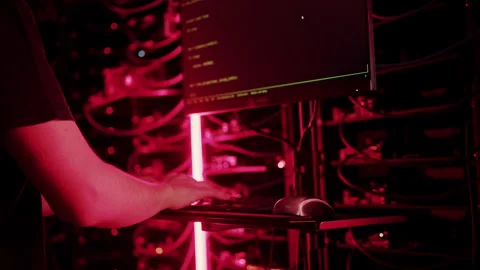 Close up of a man punching the keypad on a computer in a server room with Stock Footage 287413555